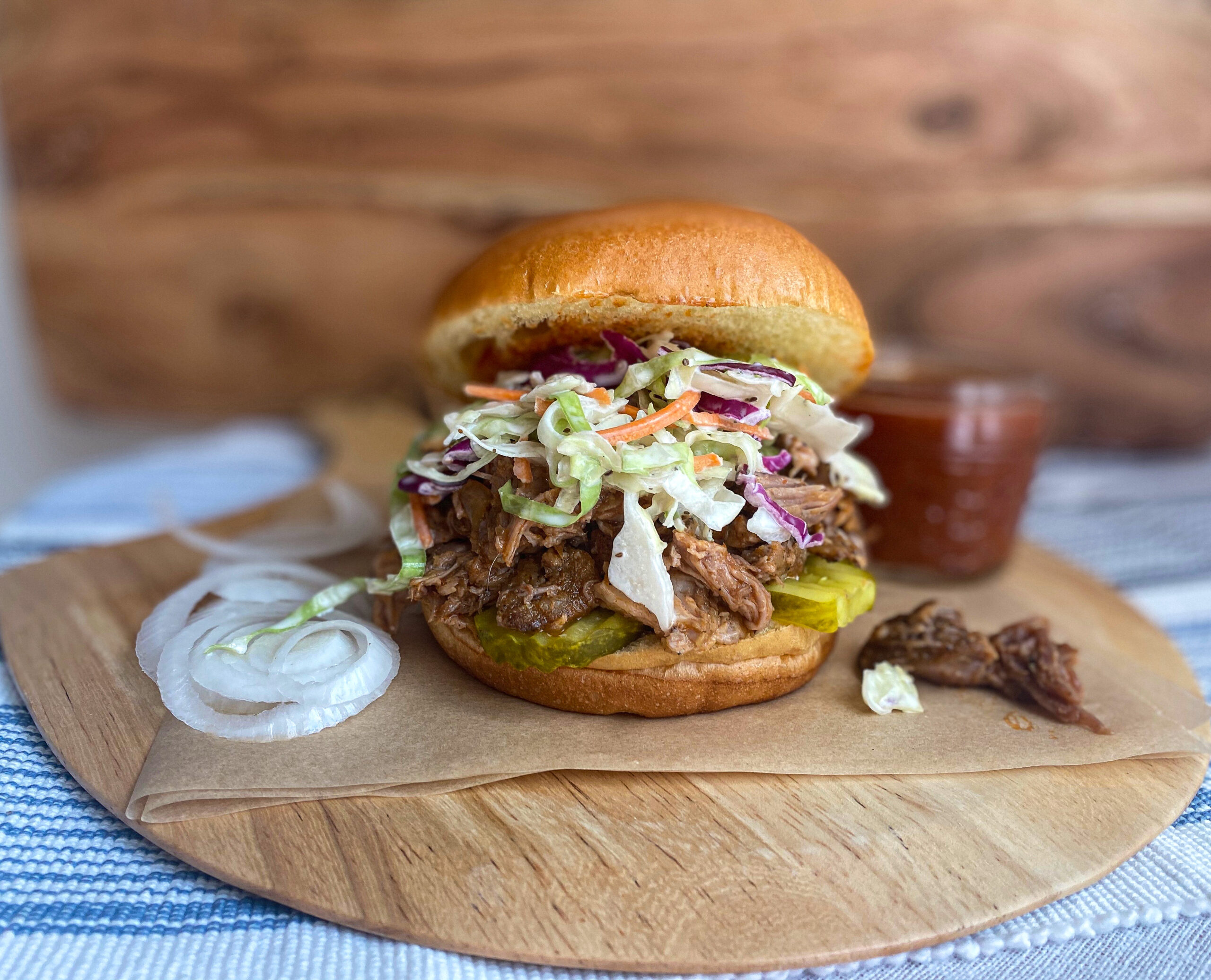 pulled pork sandwiches with homemade BBQ sauce and coleslaw on brioche bun slow cooker