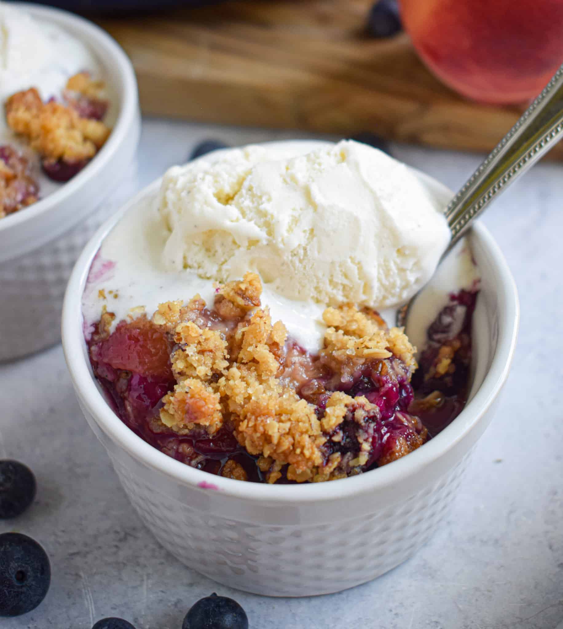 blueberry crisp crumble summer dessert with vanilla ice cream