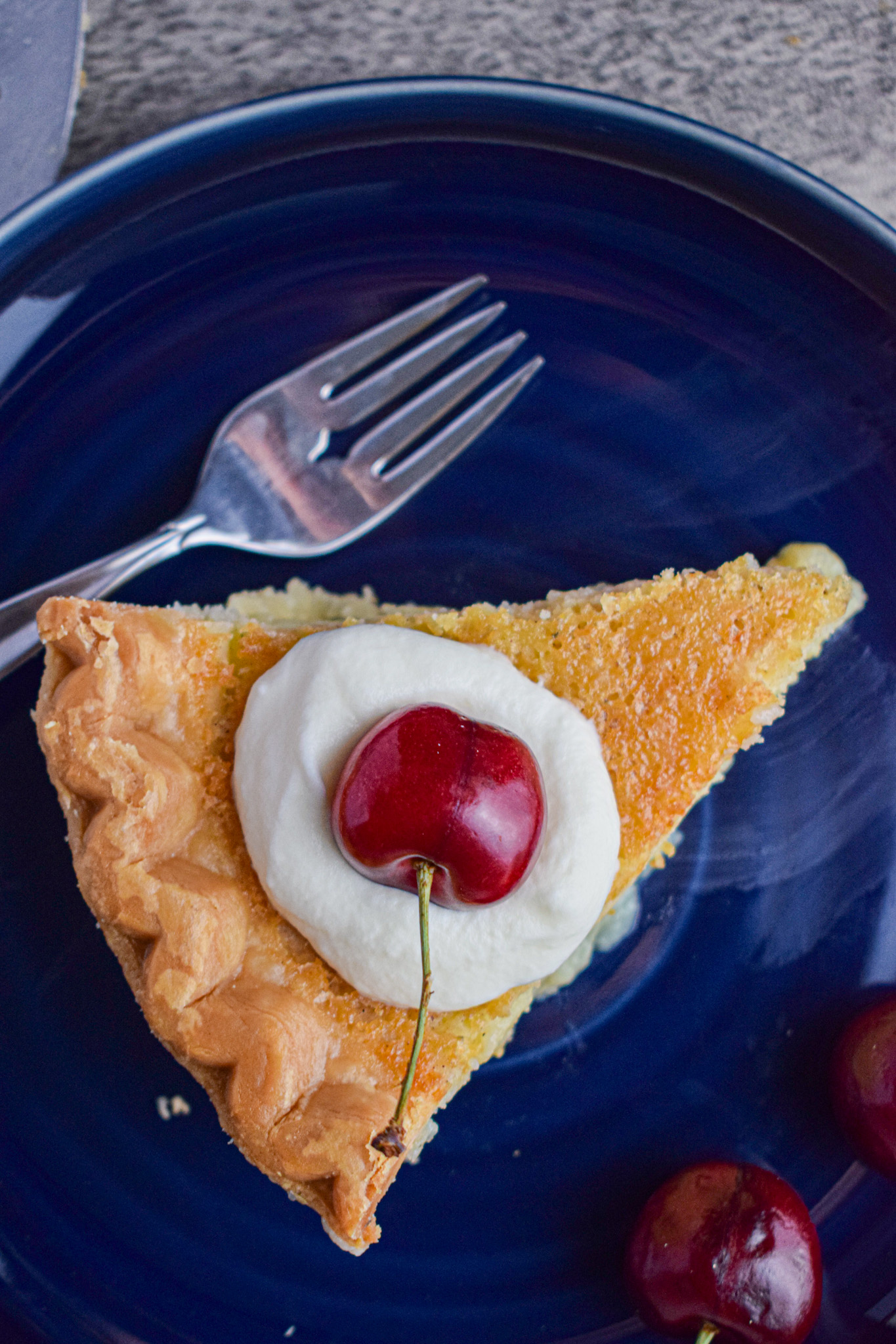 buttermilk custard pie with whipped cream and a cherry 