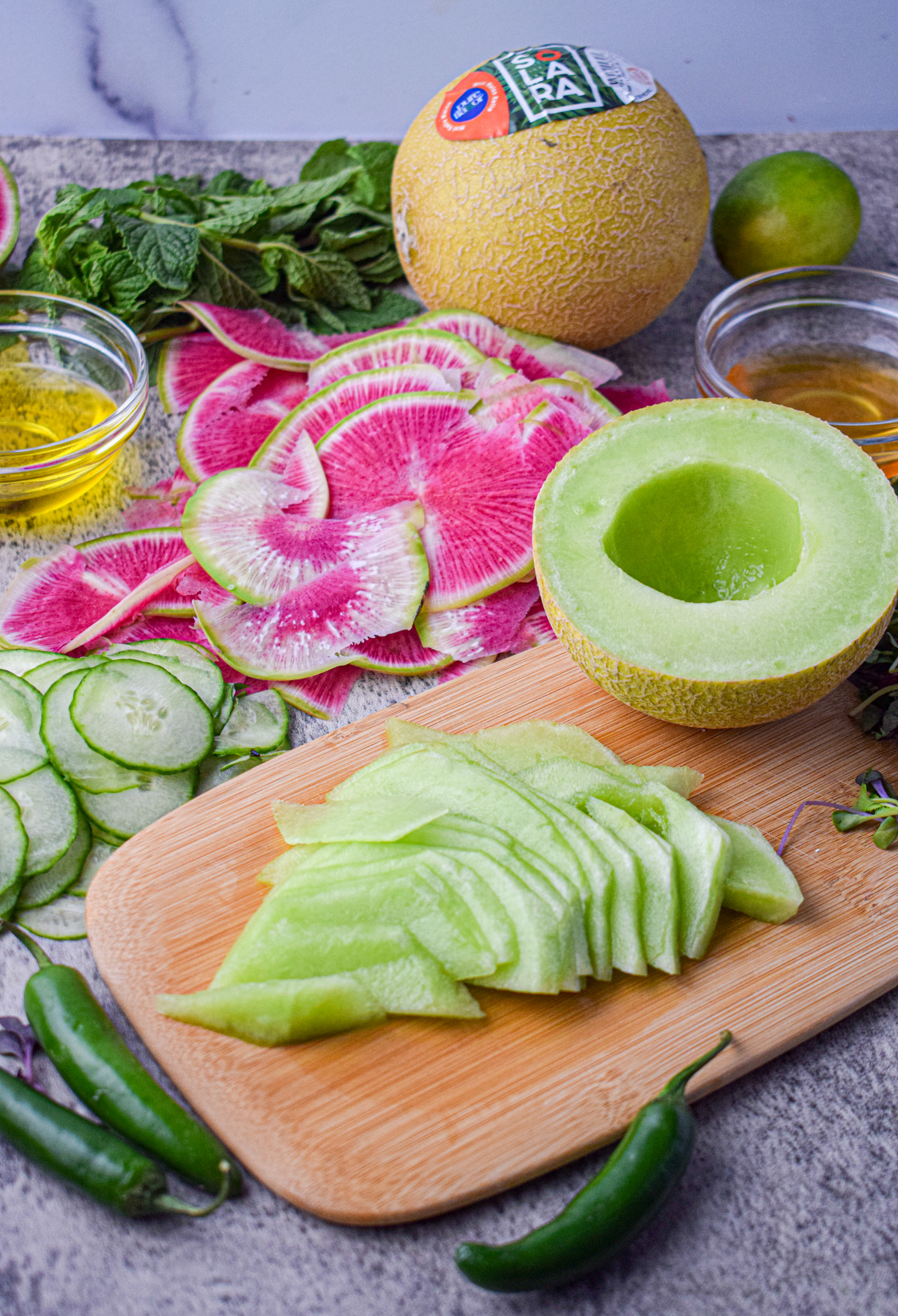 sliced solara green melon, cucumber and watermelon radish for a summer salad recipe