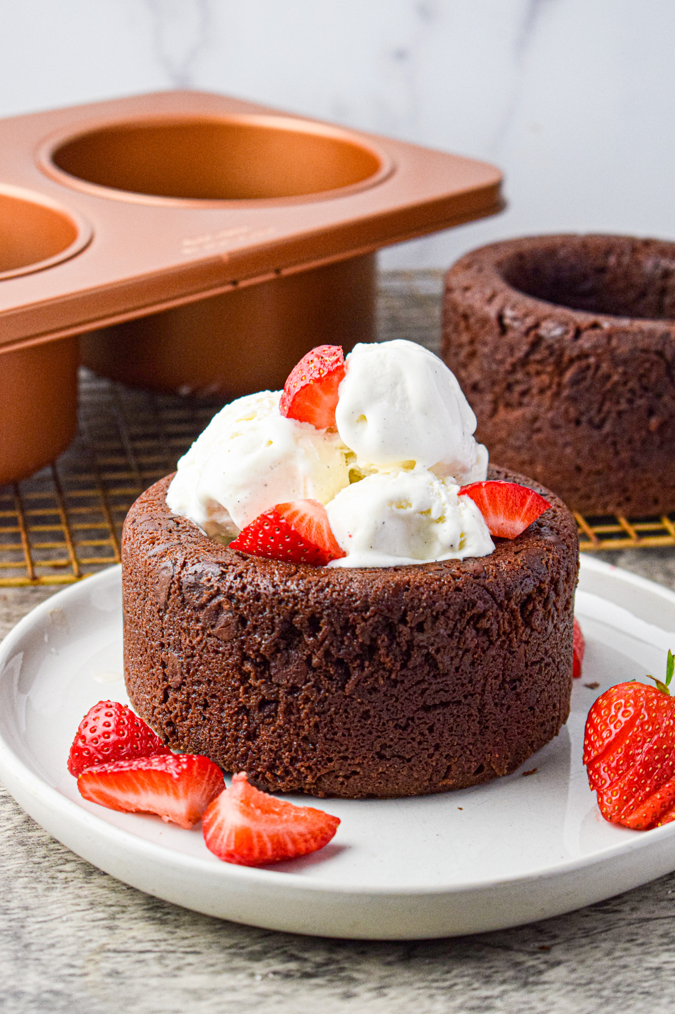 edible brownie bowls filled with ice cream and topped with fresh strawberries 