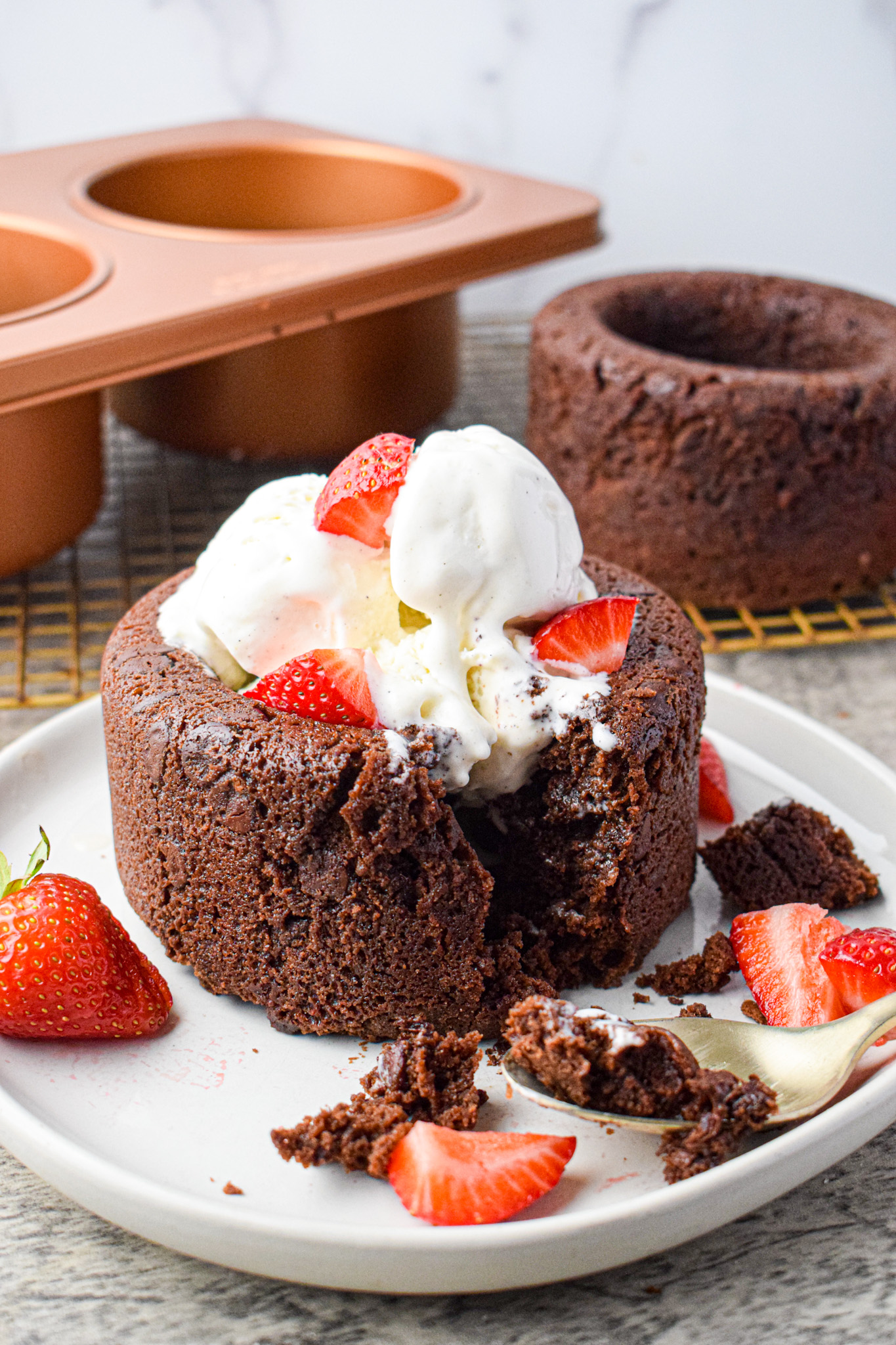 brownie filled with ice cream and strawberries with a spoon 