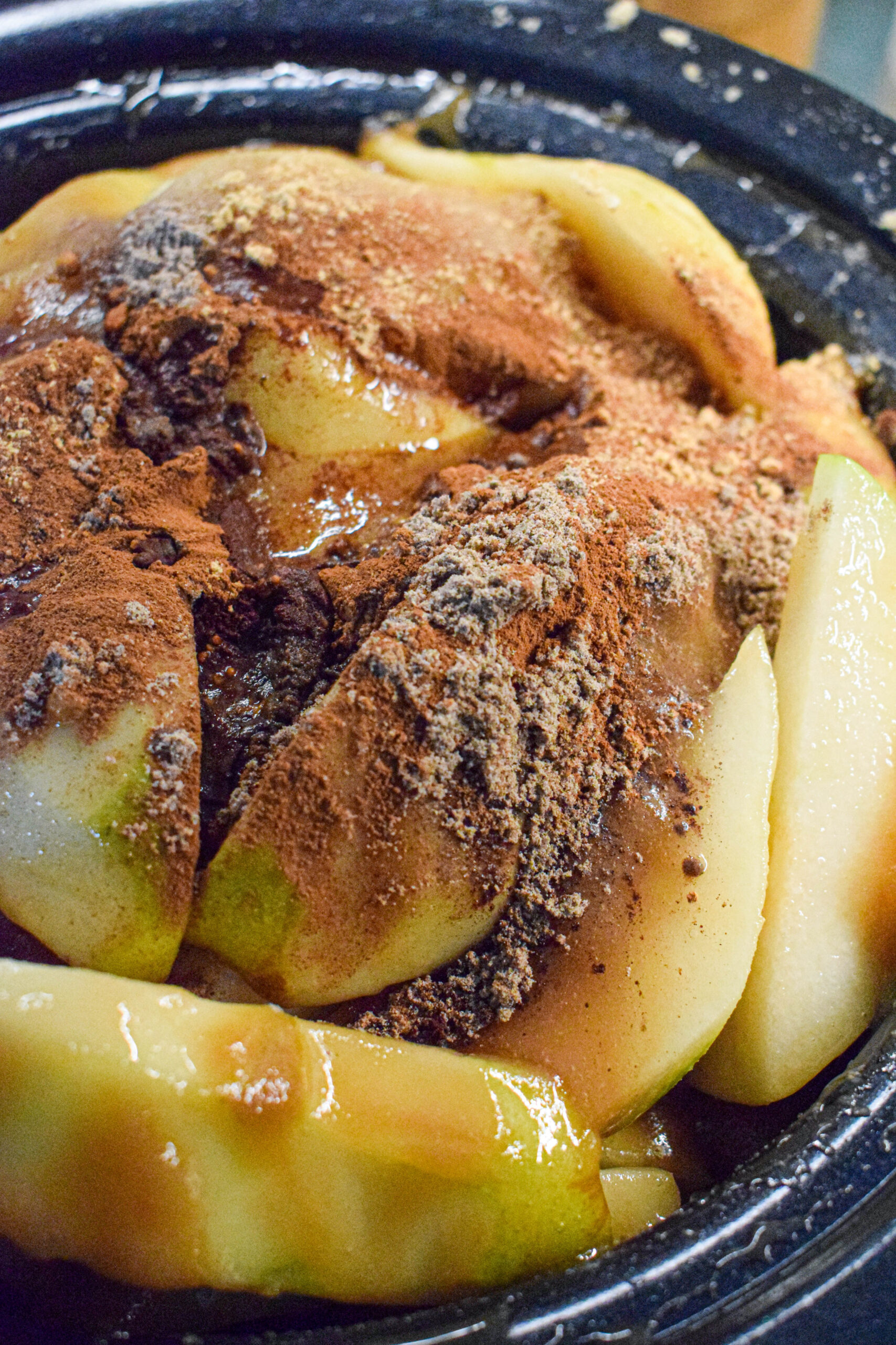 slow cooker full of pears, sugar and spices for pear butter