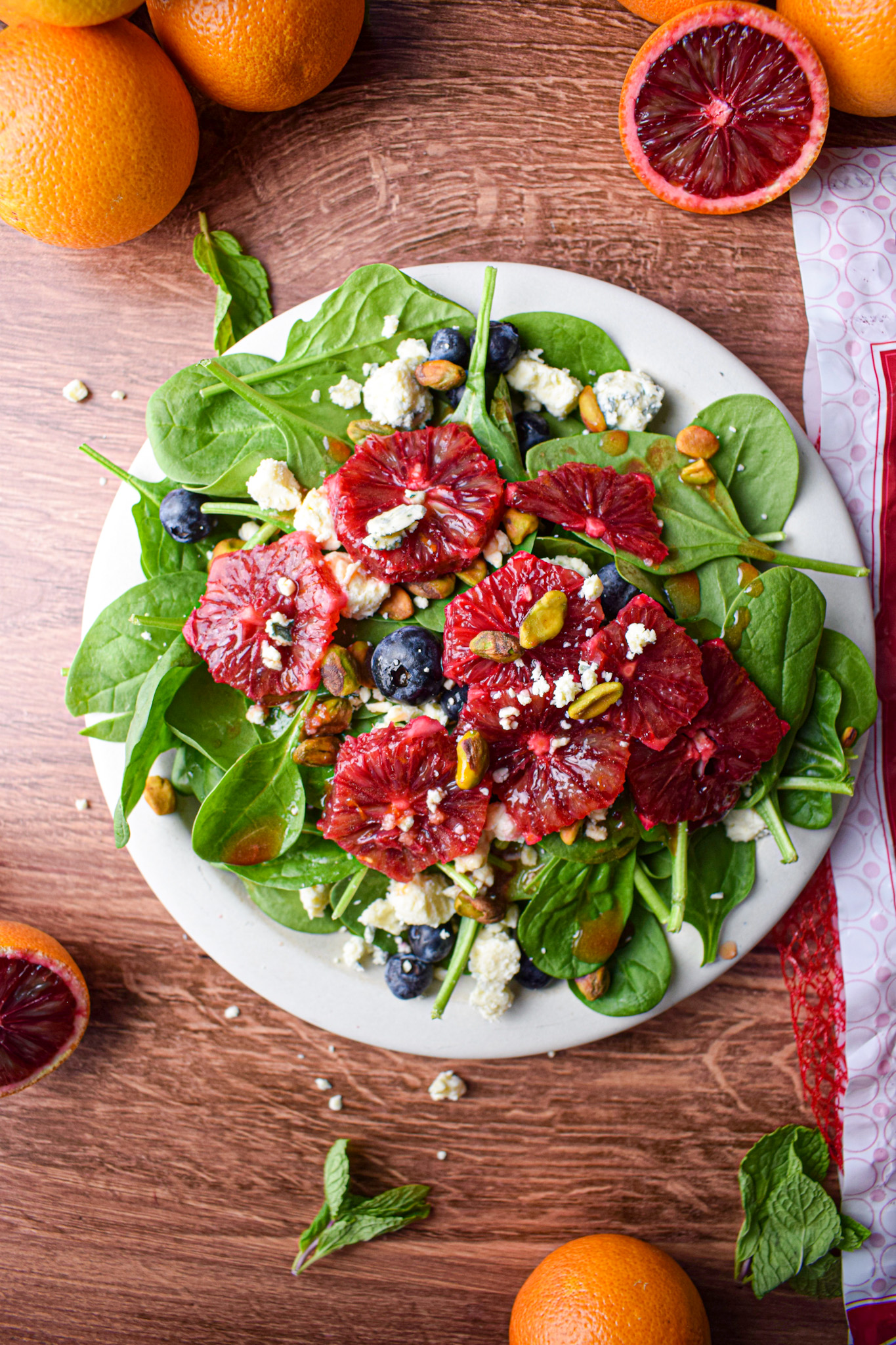 spinach salad with blueberries, blue cheese, pistachios and blood orange slices 