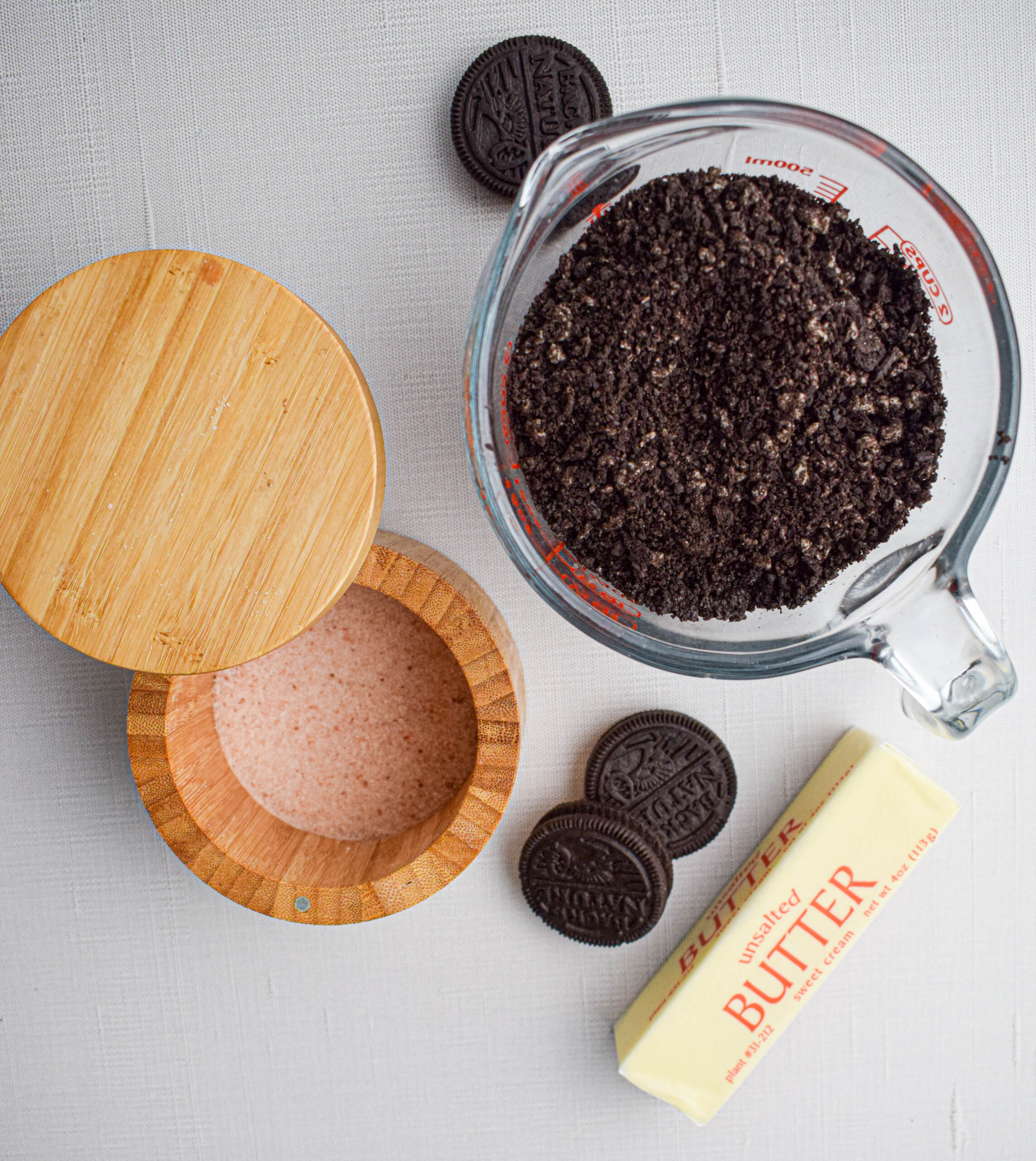 ingredients for a homemade Oreo pie crust: crushed Oreos, salt and butter