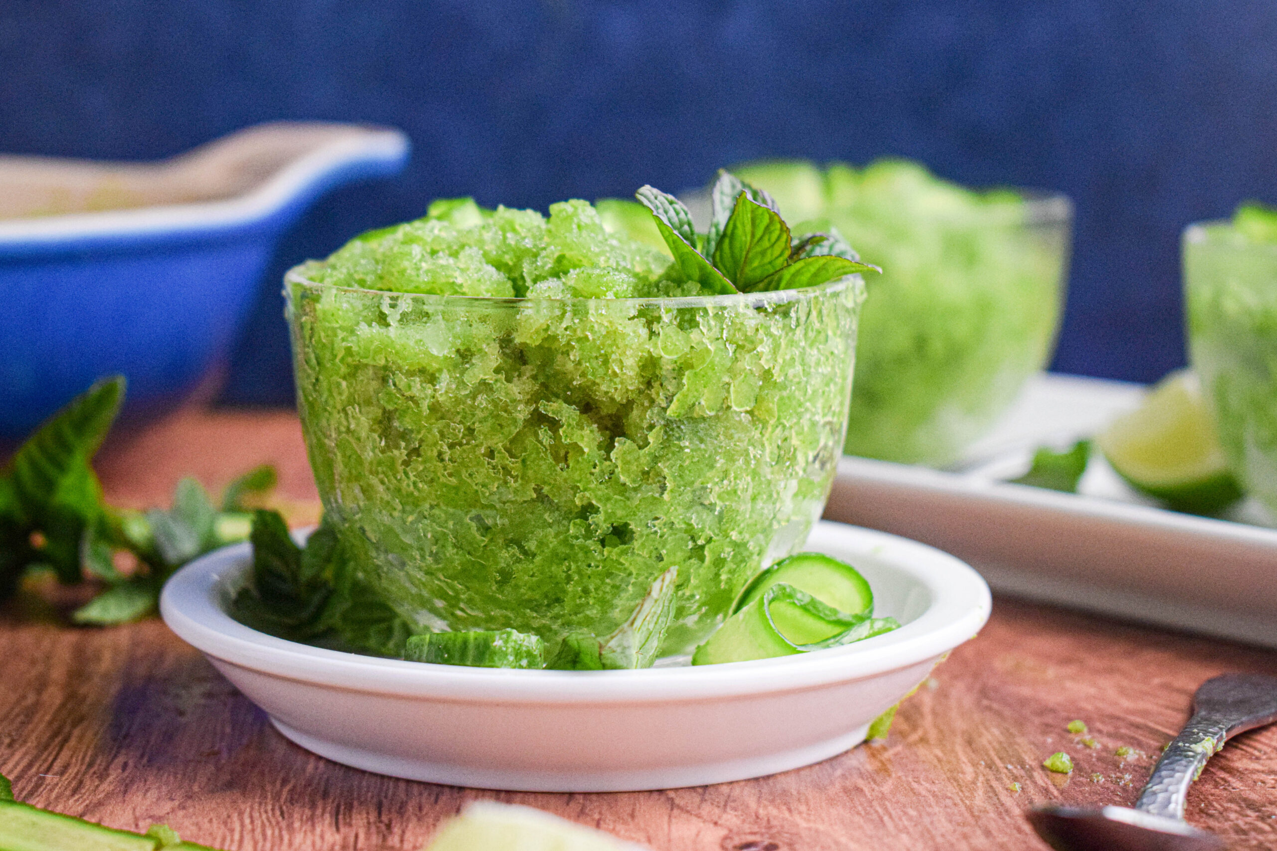 cucumber granita in a glass tea cup with cucumber slices and mint leaves