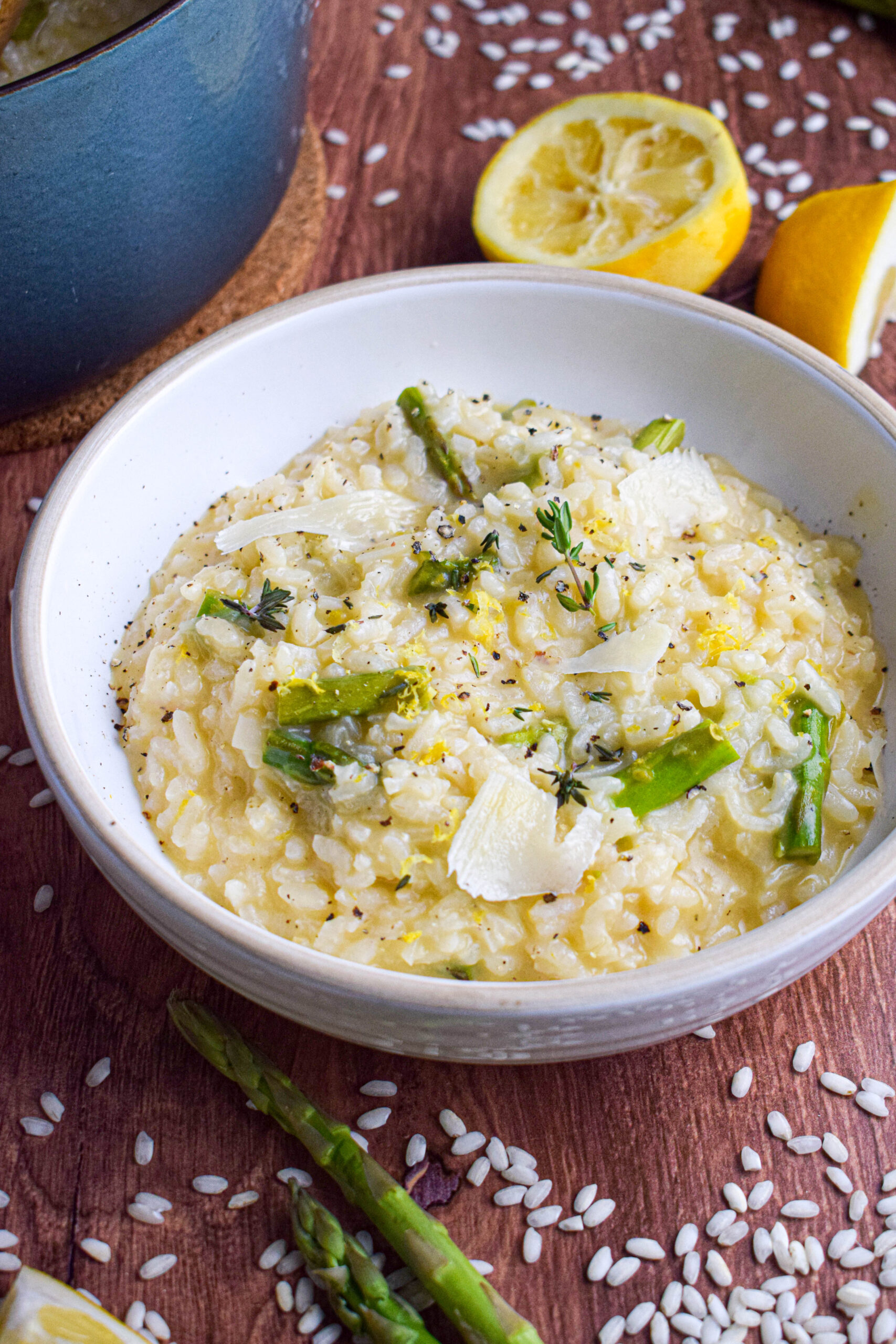 bowl of lemon risotto with asparagus topped with shaved parmesan 